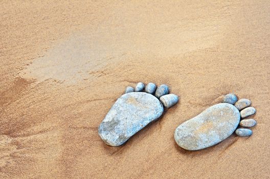 Stone traces of the pebbles on a sandy beach