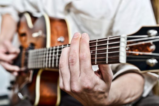 close-up on the fingers of the guitarist