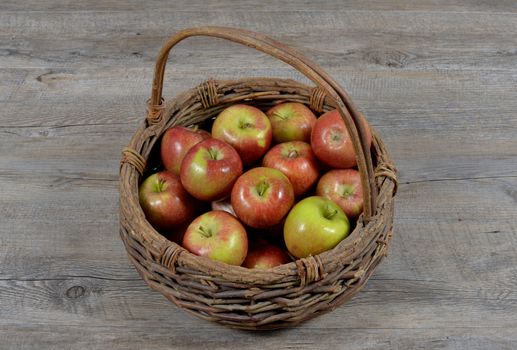 basket of apples on wood table