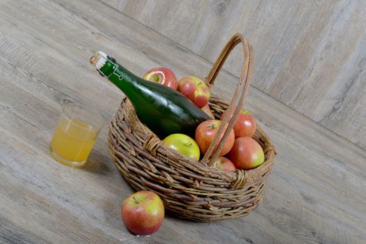 Apple basket and bottle with a glass of Norman cider