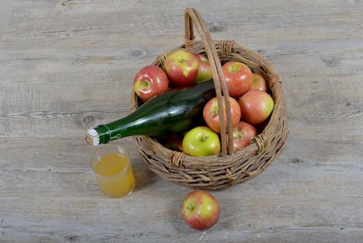 Apple basket and bottle with a glass of Norman cider