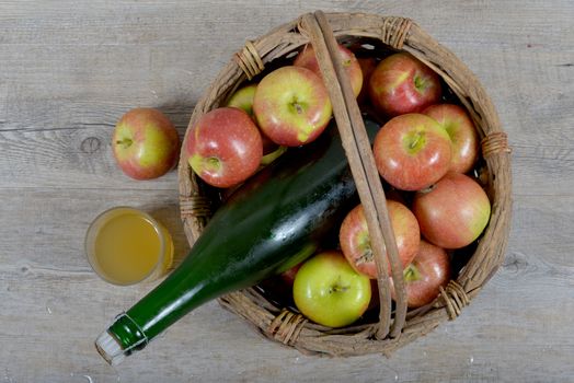 Apple basket and bottle with a glass of Norman cider