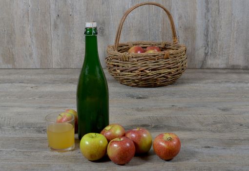 Apple basket and bottle with a glass of Norman cider