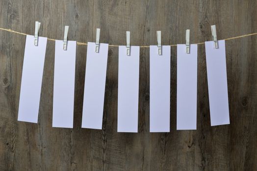 seven sheets of paper hanging on a clothesline