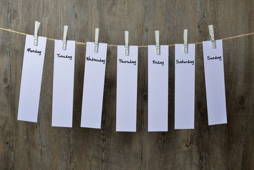 seven sheets of paper hanging on a clothesline