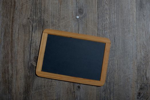 little schoolboy slate hanging on a wooden wall
