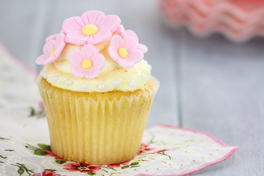 Pretty yellow and pink cupcakes with extreme shallow depth of field.