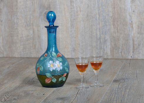 Former decanter with two small glasses with liqueur
