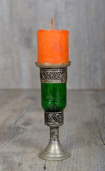 candle colorful oriental style with a silver holder
