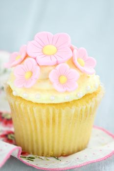 Pretty yellow and pink cupcakes with extreme shallow depth of field.