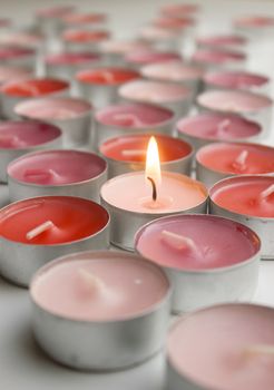 Different colors of candles in a indoor composition.