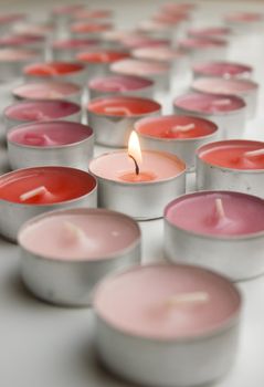 Different colors of candles in a indoor composition.