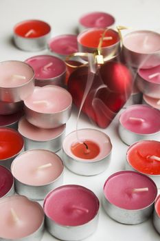 Different colors of candles in a indoor composition.