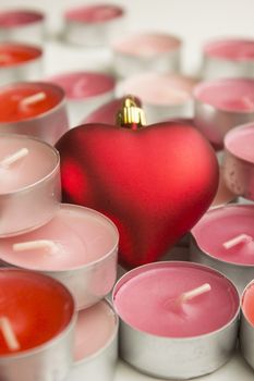 Different colors of candles in a indoor composition.