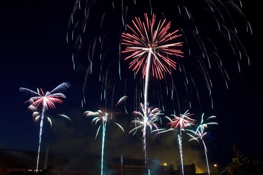 colorful fireworks into the night sky of the city