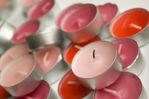 Different colors of candles in a indoor composition.