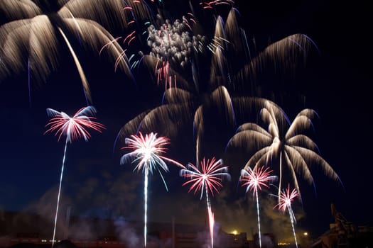 colorful fireworks into the night sky of the city