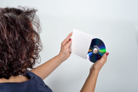 young woman holding a CD and its case