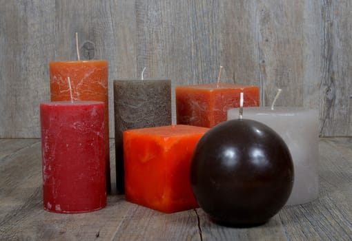 Several ornamental candles of different colors
