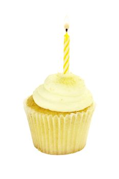 Isolated birthday cupcake with burning candles. Clipping path included.