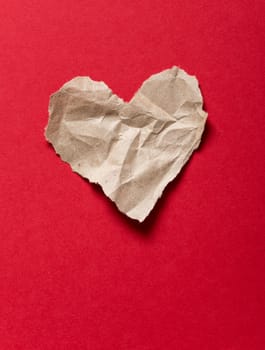 Torn paper heart on a red background