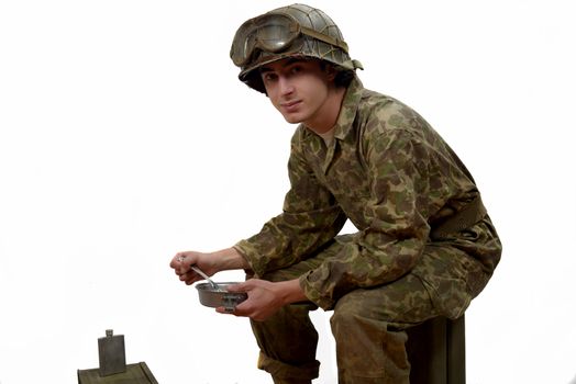 young American soldier in camouflage uniform, takes his meals