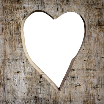 Heart shape carved into a wooden plank, white copy space