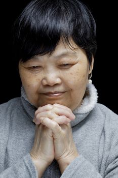 Asian woman praying and praising the Lord