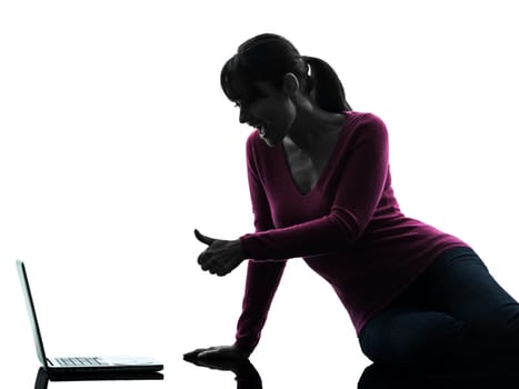 one caucasian woman thumb up computing laptop computer in silhouette studio isolated on white background