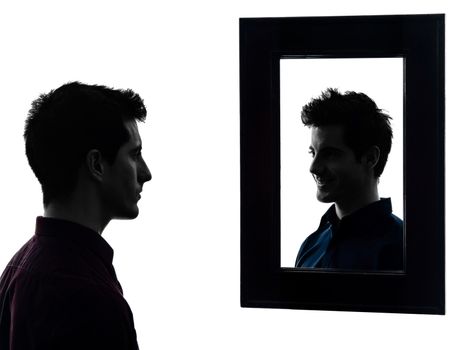 man in front of his mirror serious in shadow white background