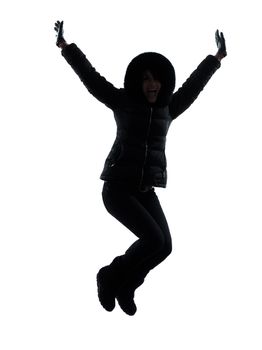 one woman in winter coat jumping happy silhouette on white background