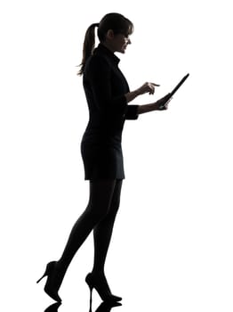one business woman walking computer computing typing digital tablet silhouette studio isolated on white background