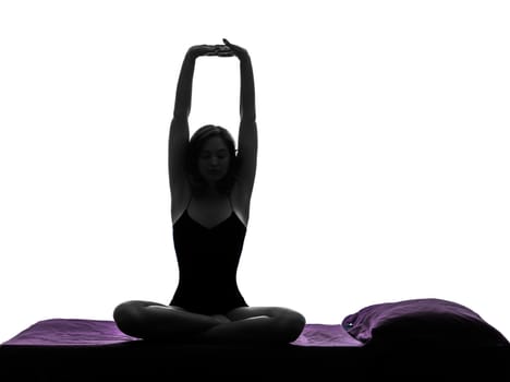 one woman waking up stretching arms in bed silhouette studio on white background