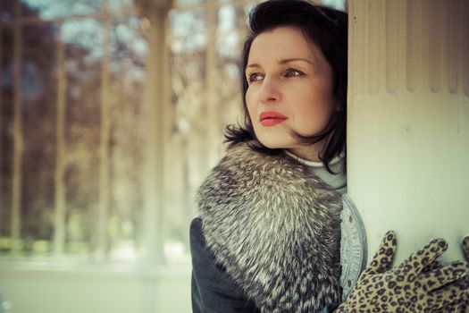 Palace.Beautiful woman in winter.Beauty Fashion Model Girl in a Fur Hat. Russian Stylish young.Portrait.