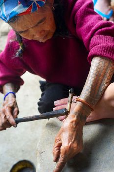 KALINGA, PHILIPPINES - MARCH 29, 2012: Unidentified woman makes traditional Cordillerans tattooing . Indigenous groups in Philippines have been practising the art of tattooing for centuries