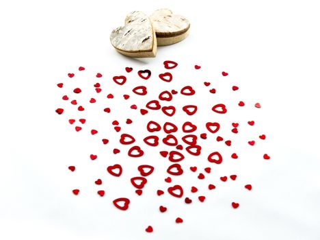 Red hearts and wooden hearts on white background for Valentines day and love concept