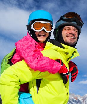 Ski, winter, snow, skiers, sun and fun - family enjoying winter vacations.