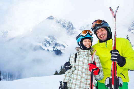 Ski, winter, snow, skiers, sun and fun - family enjoying winter vacations.