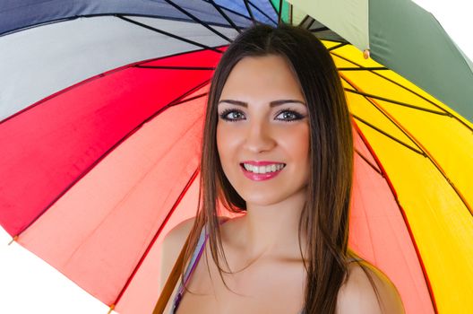 Close up portrait of beautiful brunette female with rainbow umbrella over white background 