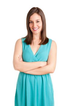 Portrait of a young brunette woman with her arms crossed, smiling, isolated in white