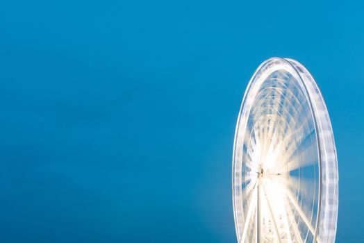 Fairy wheel in an amusement park during night time, taken at slow shutter.