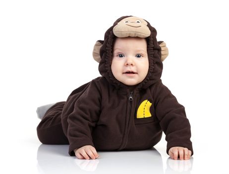Baby boy dressed in monkey costume over white background