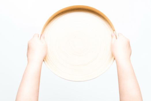 Asian woman holding orange plate, isolated