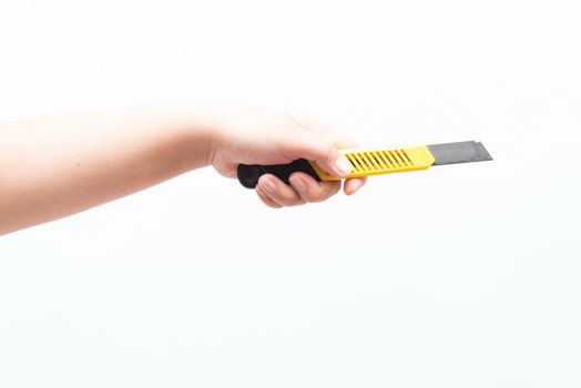 Asian woman holding a yellow box cutter knife, isolated