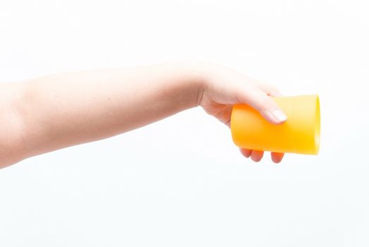 Asian woman holding a small plastic cup, isolated