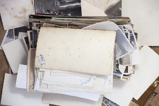 Stack of old photos with one turned up photo for your image or copy.