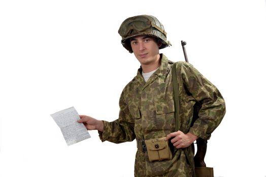 young American soldier in camouflage uniform shows a photograph