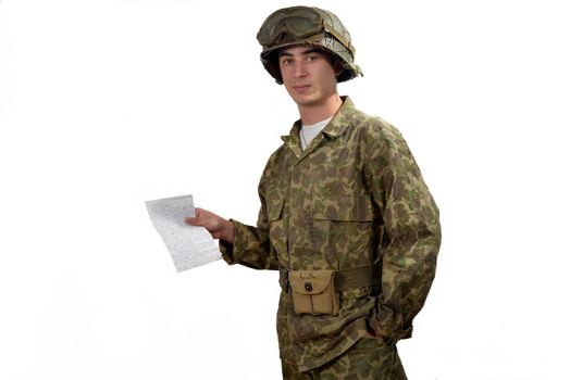 young American soldier in camouflage uniform shows a letter