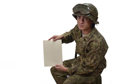 young American soldier in camouflage uniform shows a letter