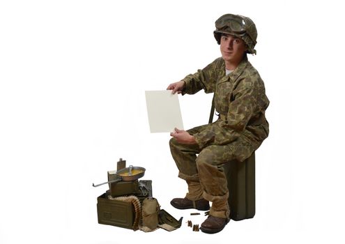 young American soldier in camouflage uniform shows a letter